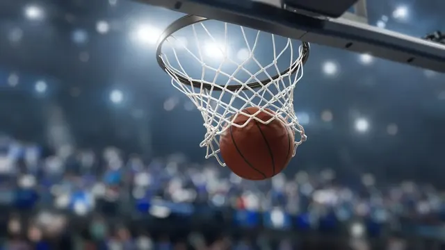 Illustration of a basketball swishing through a net under bright arena lights with a blurred crowd behind